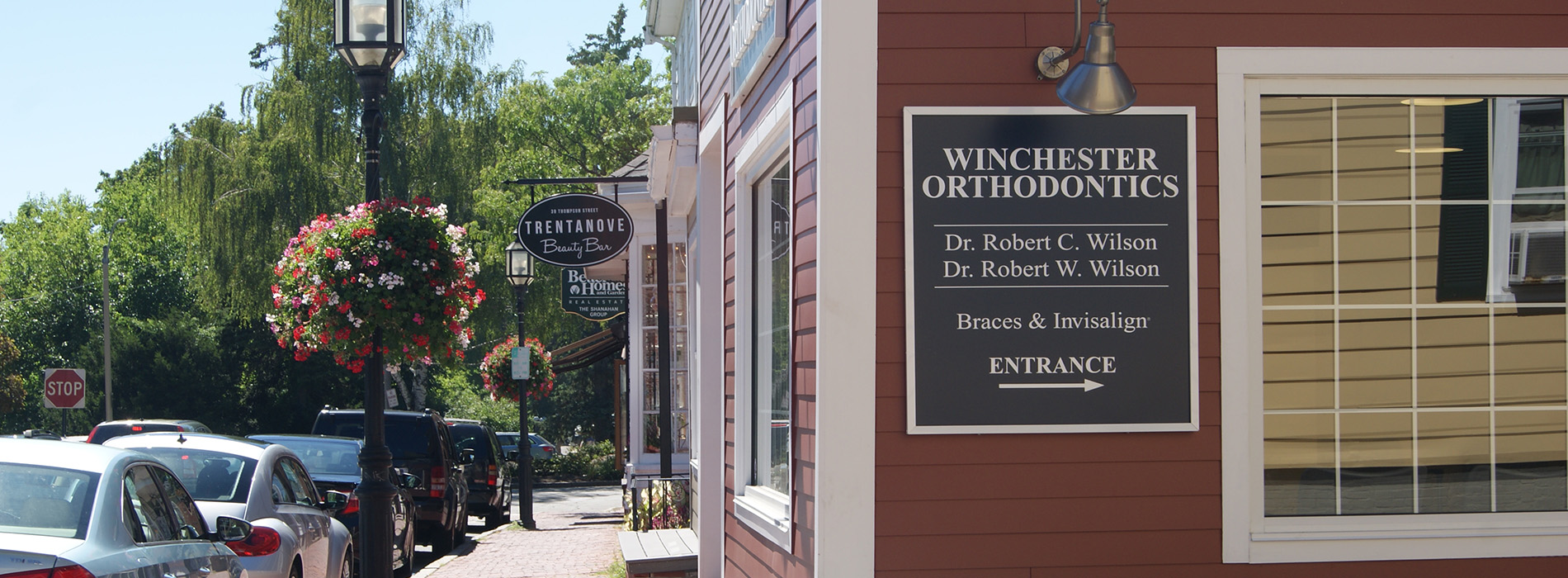 A real estate sign on a building with a red and white striped facade.