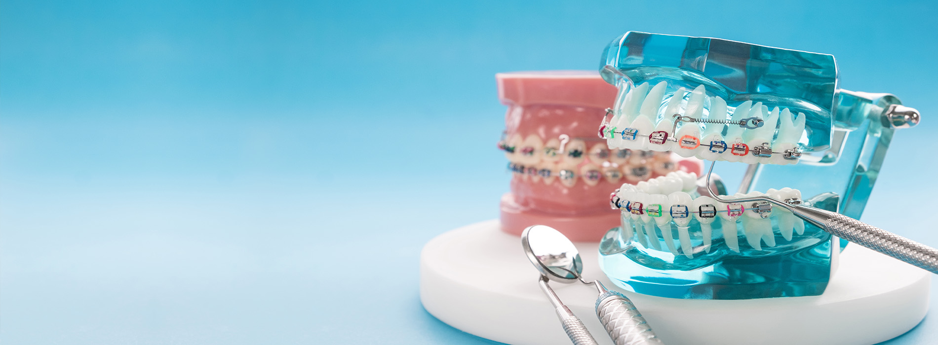 The image features a collection of toothbrushes with bristles and heads in various colors, displayed against a blue background.