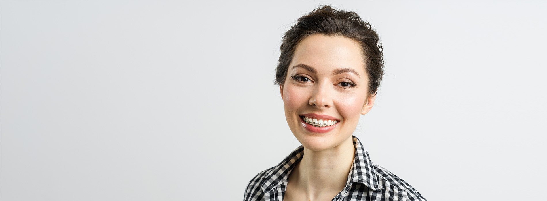 A woman with short hair is smiling at the camera.