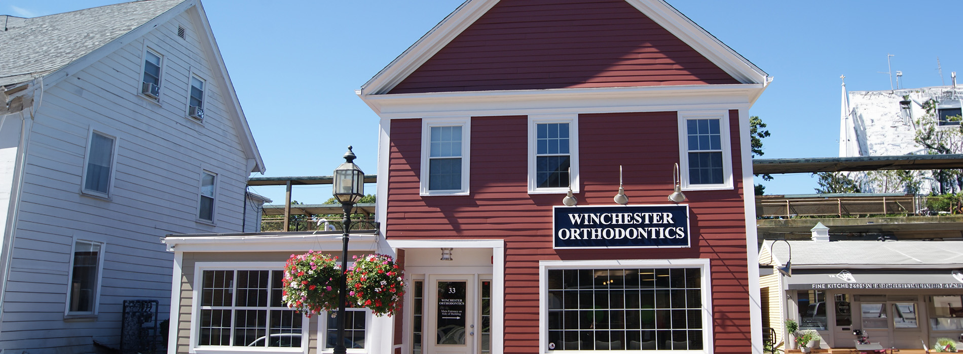 A red building with a white sign reading  Chester  in front of it, situated on the corner of a street.