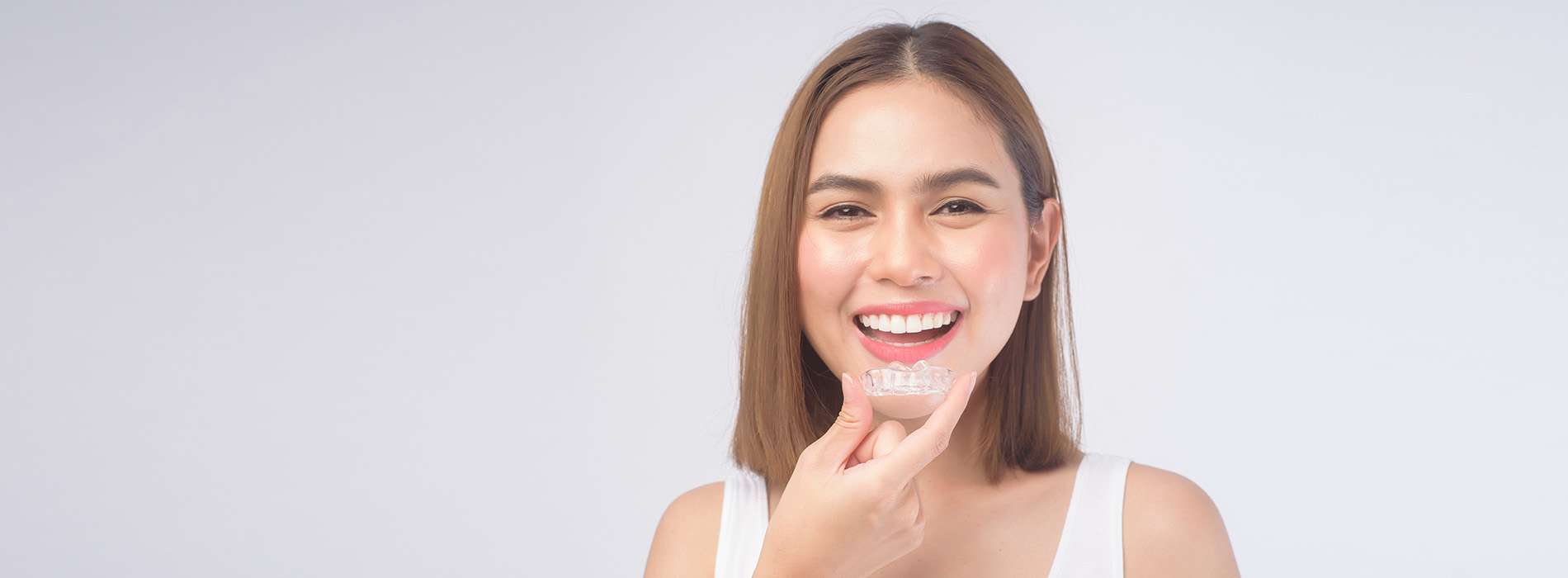 A woman with a radiant smile against a white background.