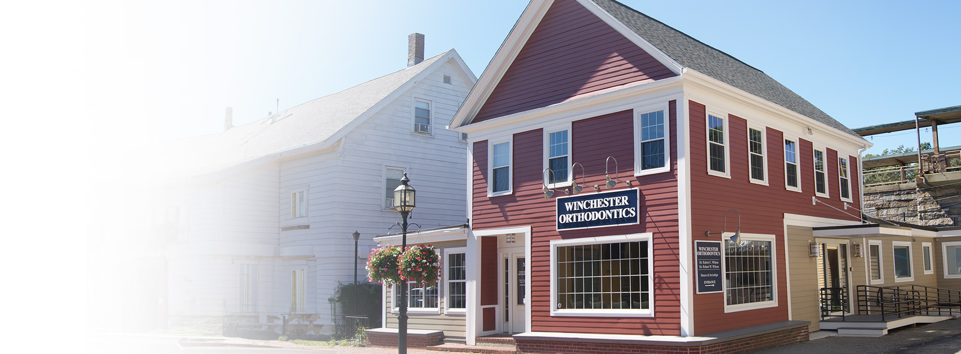 The image depicts a red brick building with white trim, featuring a sign that reads  The Red House Inn  and the text  BED   BREAKFAST  beneath it.